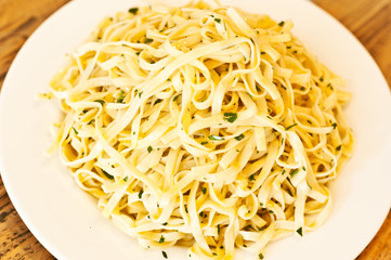 overhead view of pasta on a white plate