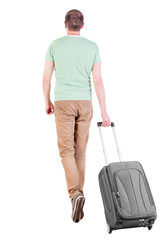 back view of walking  man  with suitcase.