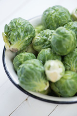Bowl with fresh brussels, close-up, studio shot