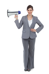 Fototapeta premium Smiling businesswoman holding loudspeaker