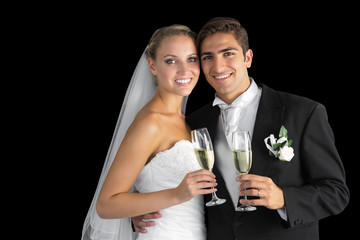 Sweet young couple posing with champagne glasses