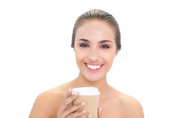 Cheerful brunette woman holding a cup of coffee