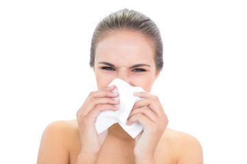 Young brunette woman using a tissue