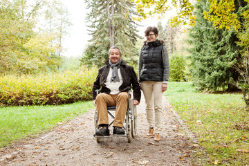 Woman next to man in wheelchair - 57291903