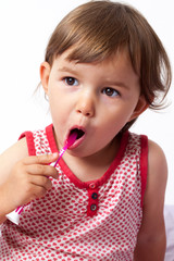 2-year old baby brushing her teeth with conviction