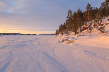 Fototapeta na wymiar Winter, coast of the frozen of morning lake.
