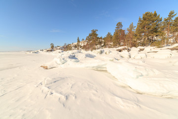 Winter, coast of the frozen lake In the sunny day.
