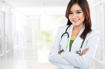 Smiling asian doctor wearing a white coat and stethoscope with a