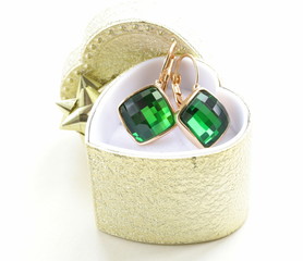 golden earrings with green stones in a gift box © Olga Kriger