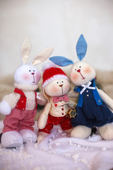 Christmas toy rabbits on the background trees