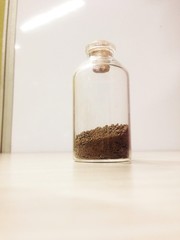 glass bottle filled with sand 