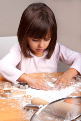 Little girl cooking cookies