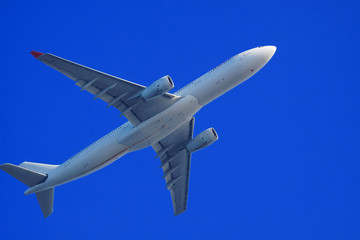 Passenger jet air plane flying on blue sky