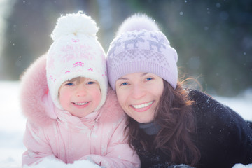 Happy family lying on snow