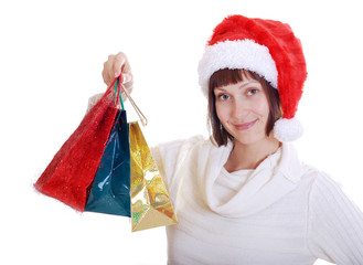 The girl in the hat of Santa Claus with holiday gifts