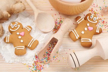 funny gingerbread men, flour, rolling pin, spoon and ginger on k
