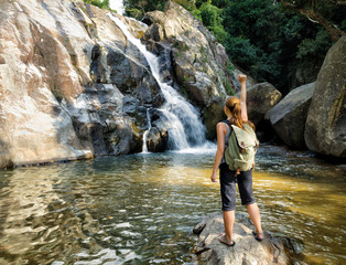 Female hiker looking at waterfall