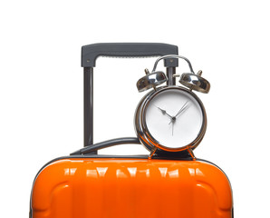 Alarm clock on orange suitcase