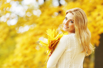 Smiling woman in autumn park