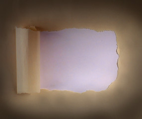 Brown package paper torn to reveal white panel