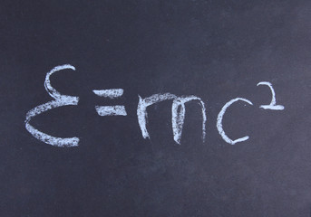 E=mc2. Theory of relativity, writings on blackboard.