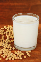 Soy beans with glass of milk on wooden background