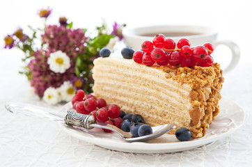 Piece of homemade honey cake with fresh berries