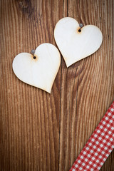 vertical wooden plank with two lovely hearts and checked ribbon