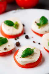 Tomato and mozzarella with basil leaves
