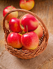 apples in a basket on wooden background