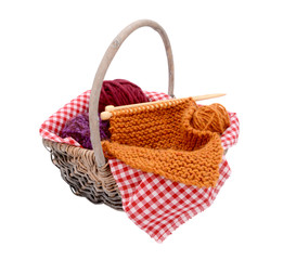 Fototapeta na wymiar Purple, red and orange wool with knitting in a basket