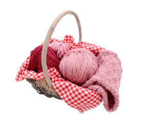Fototapeta na wymiar Pink balls of yarn with knitting in a basket
