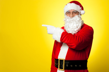 Fototapeta na wymiar Santa pointing away towards something