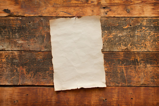 old blank paper nailed to a barn door