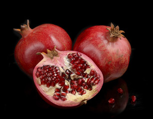 Pomegranate whole and open-face with seeds