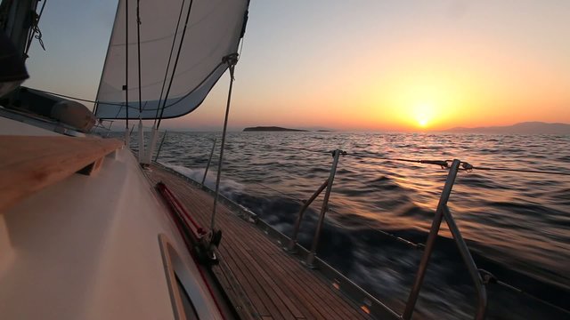 Yacht sailing against sunset. Luxury yacht. (HD)