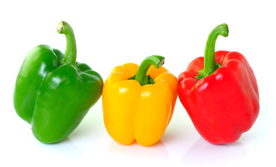 green yellow red pepper on white background
