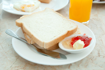 Breakfast - toasts , Orange juice  and strawberry jam