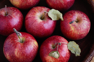 Ripe apples in rustic wooden bowl