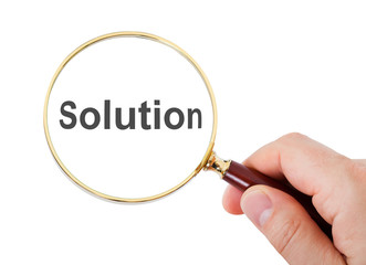 Close-up of hand looking through magnifying glass