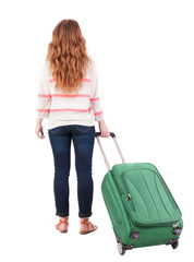 back view of walking  woman  with suitcase.