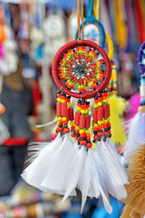 Red dream catcher with white feathers closeup - 57326556