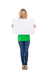 Fototapeta premium Smiling cute blonde holding white poster