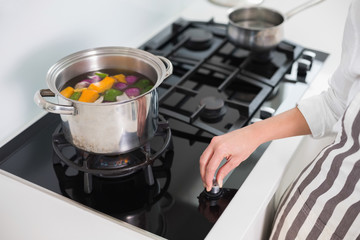 Close up on woman cooking vegetables