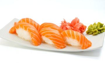 Salmon sushi nigiri on white plate and background with wasabi