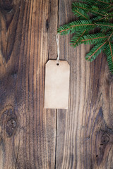 Pine tree with empty label on old wooden background
