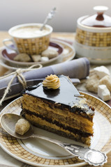 Piece of chocolate caramel cake and cup of coffee