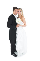 Cute young married couple posing holding a white bouquet