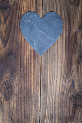 Heart slate on old wooden background