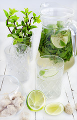 Mojito in the glass and jar, lime and cane sugar